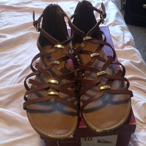 Brown sandals with gold accents